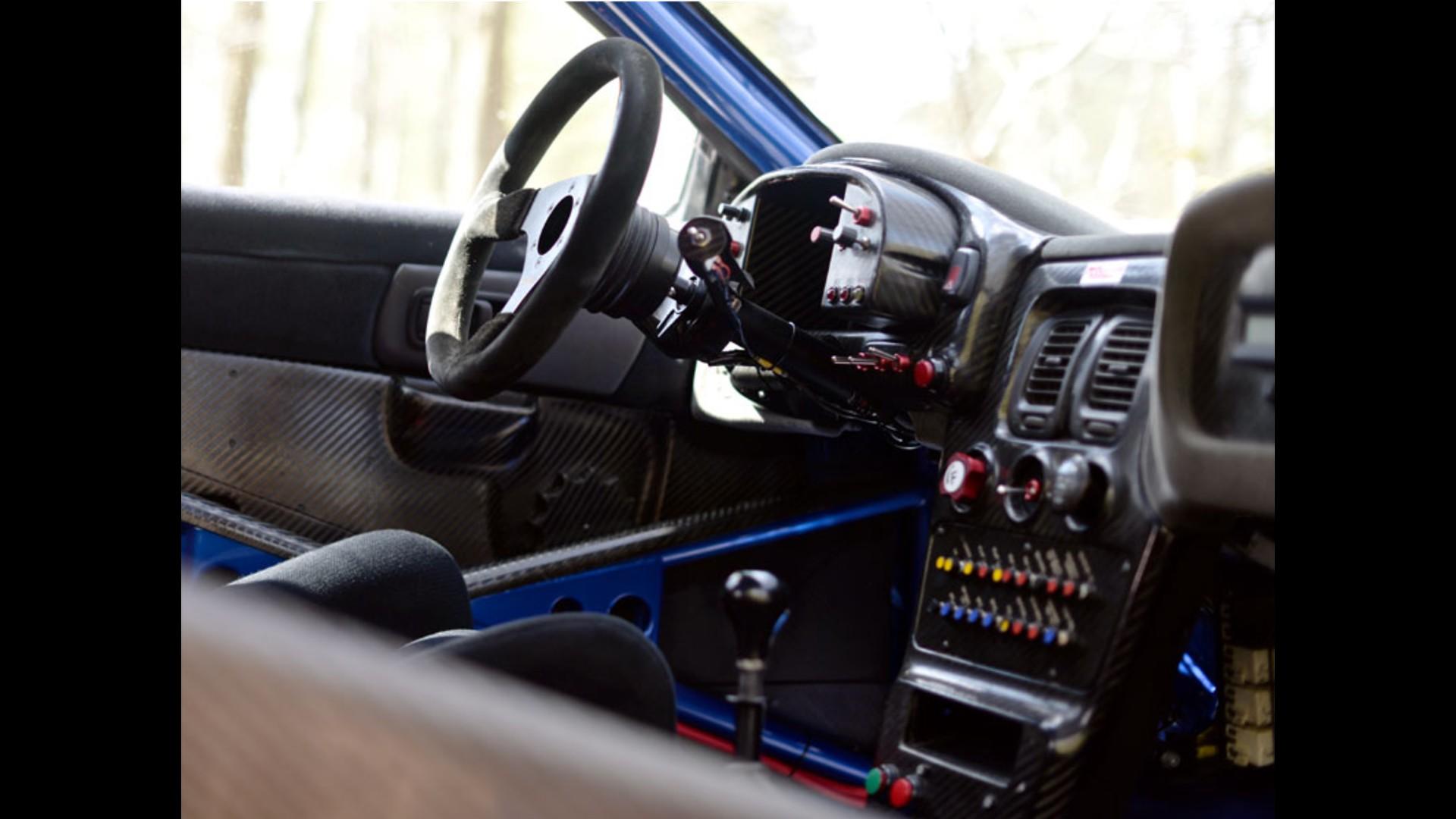 Competition-style cockpit with a roll cage and instrument panel